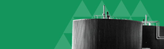 Large cylindrical industrial storage tanks, representing the Waste Management sector.